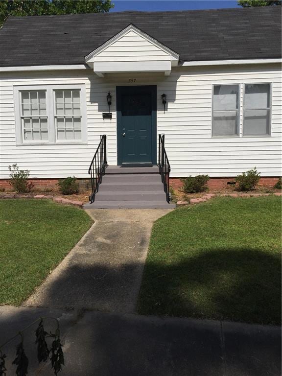 View of front of house with a shingled roof and a 
