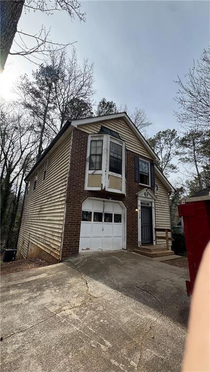 View of front of home with a garage and driveway