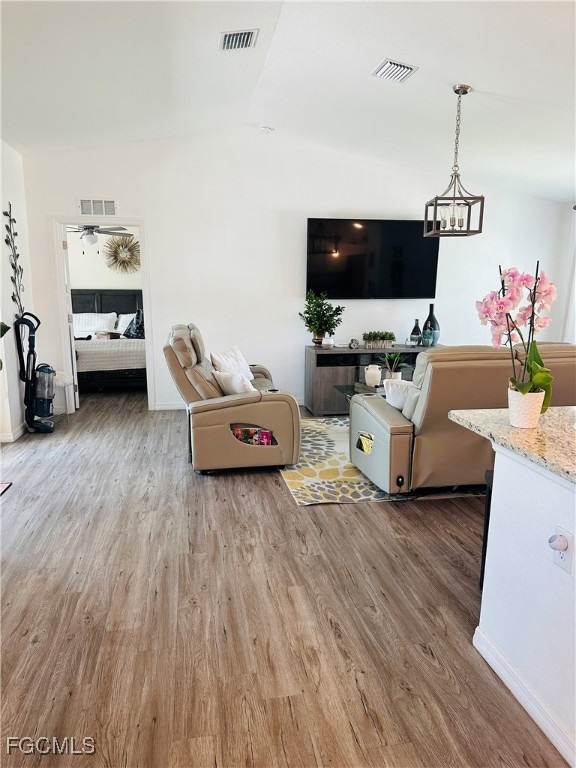 Living area with wood finished floors, lofted ceil