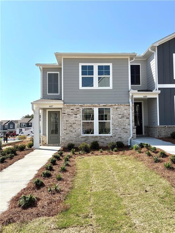 View of front of home featuring brick siding and a