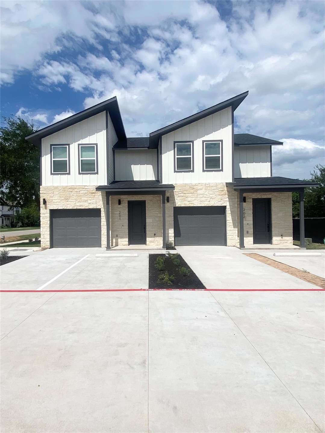 Contemporary house with a garage, board and batte