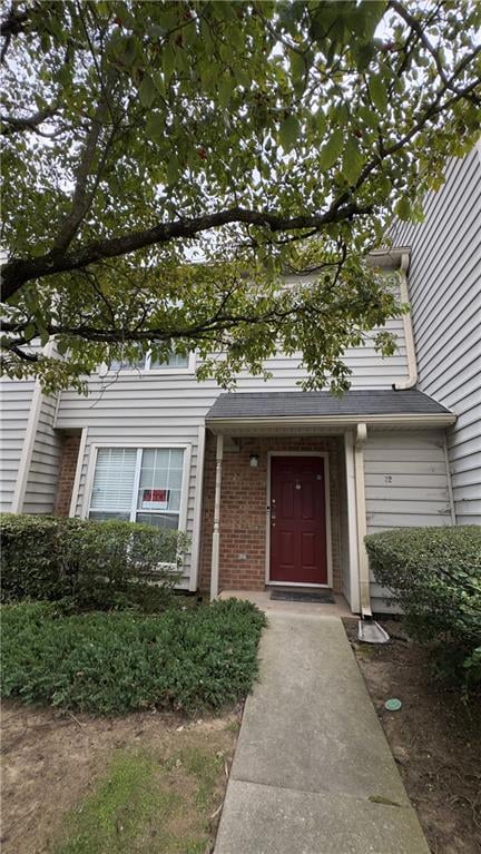 Property entrance featuring brick siding