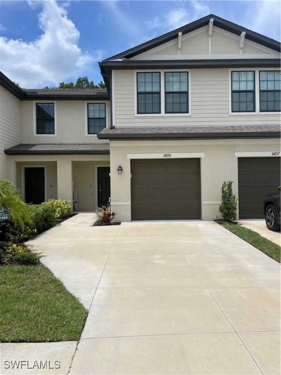 View of front of home with an attached garage, con