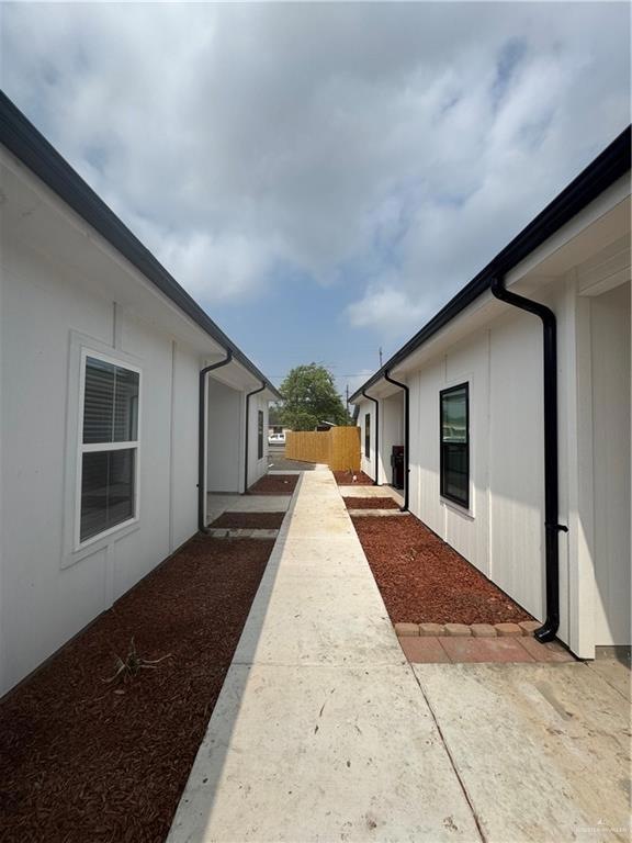 View of property exterior featuring fence