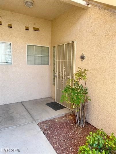 Entrance to property featuring stucco siding