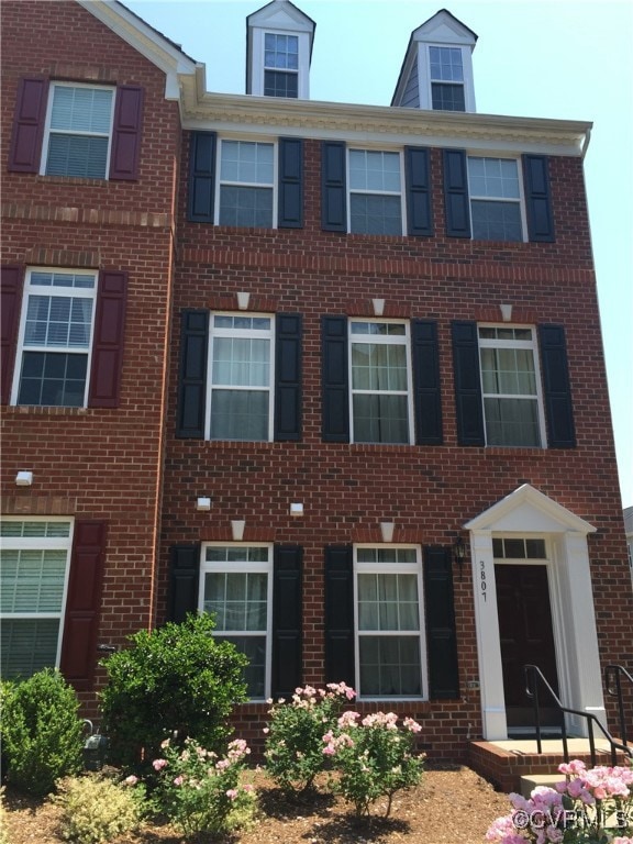 View of front facade featuring brick siding