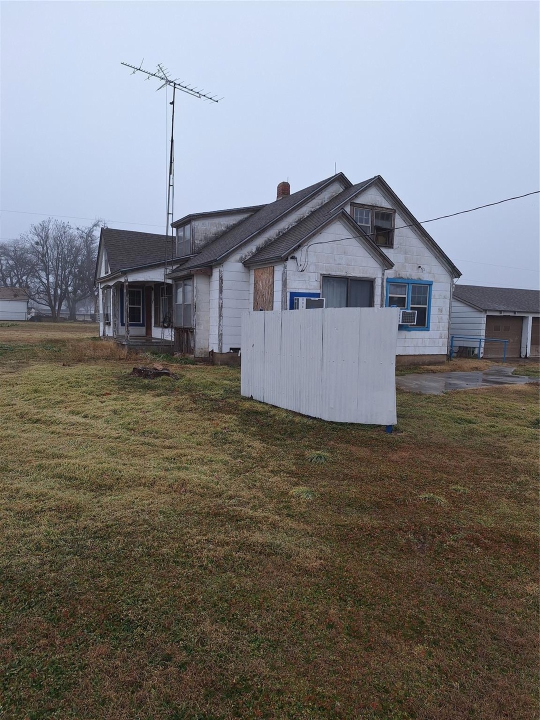View of property exterior featuring a yard and coo