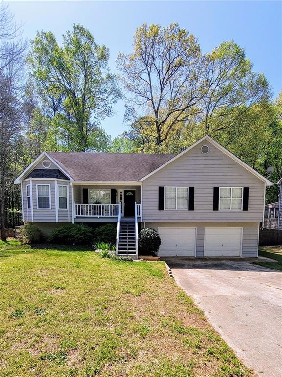 Front of home featuring covered front porch, drive