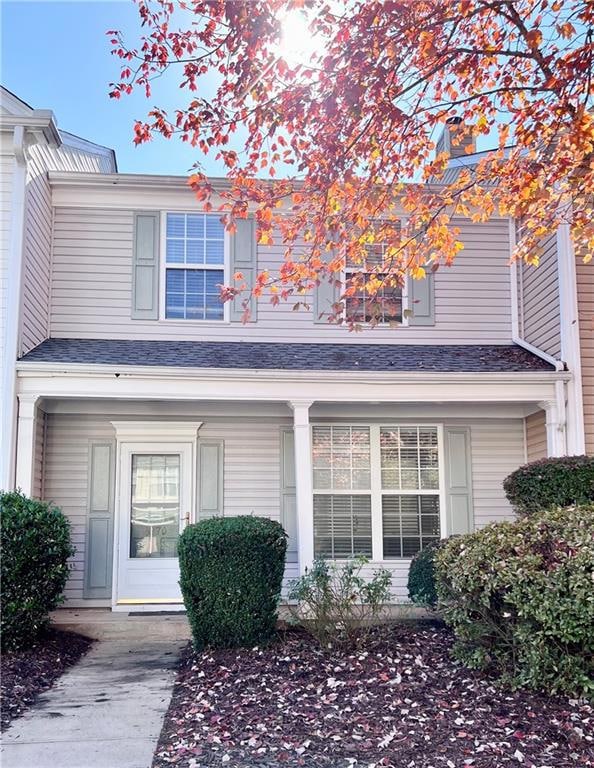 Entrance to property featuring covered porch