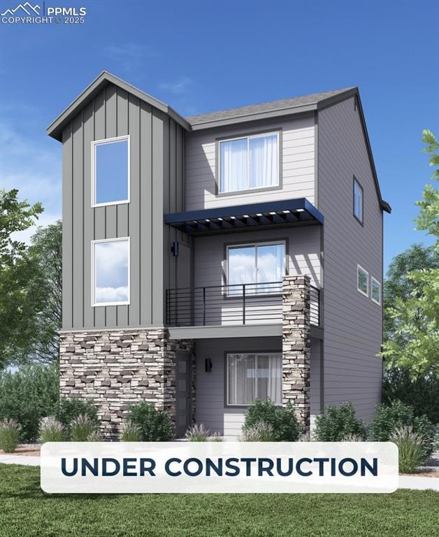 View of front of home with a balcony, stone siding, and board and batten siding