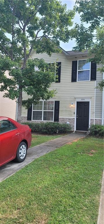 View of front of house with a front yard