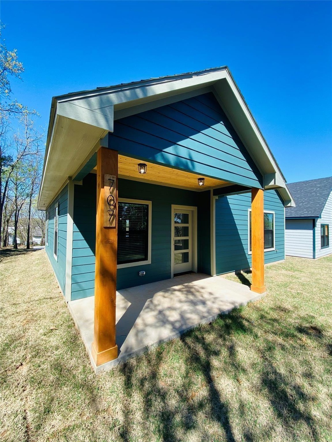 Back of property with a lawn
