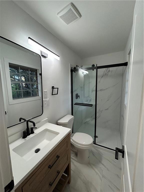 Full bathroom with a marble finish shower, vanity, and light marble finish flooring