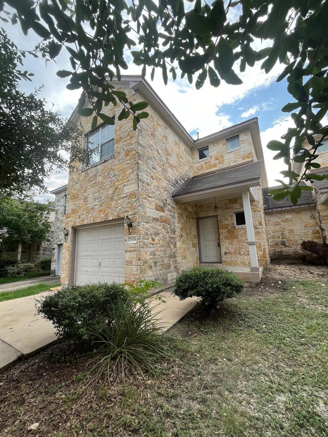 View of front of home with stone siding and an at