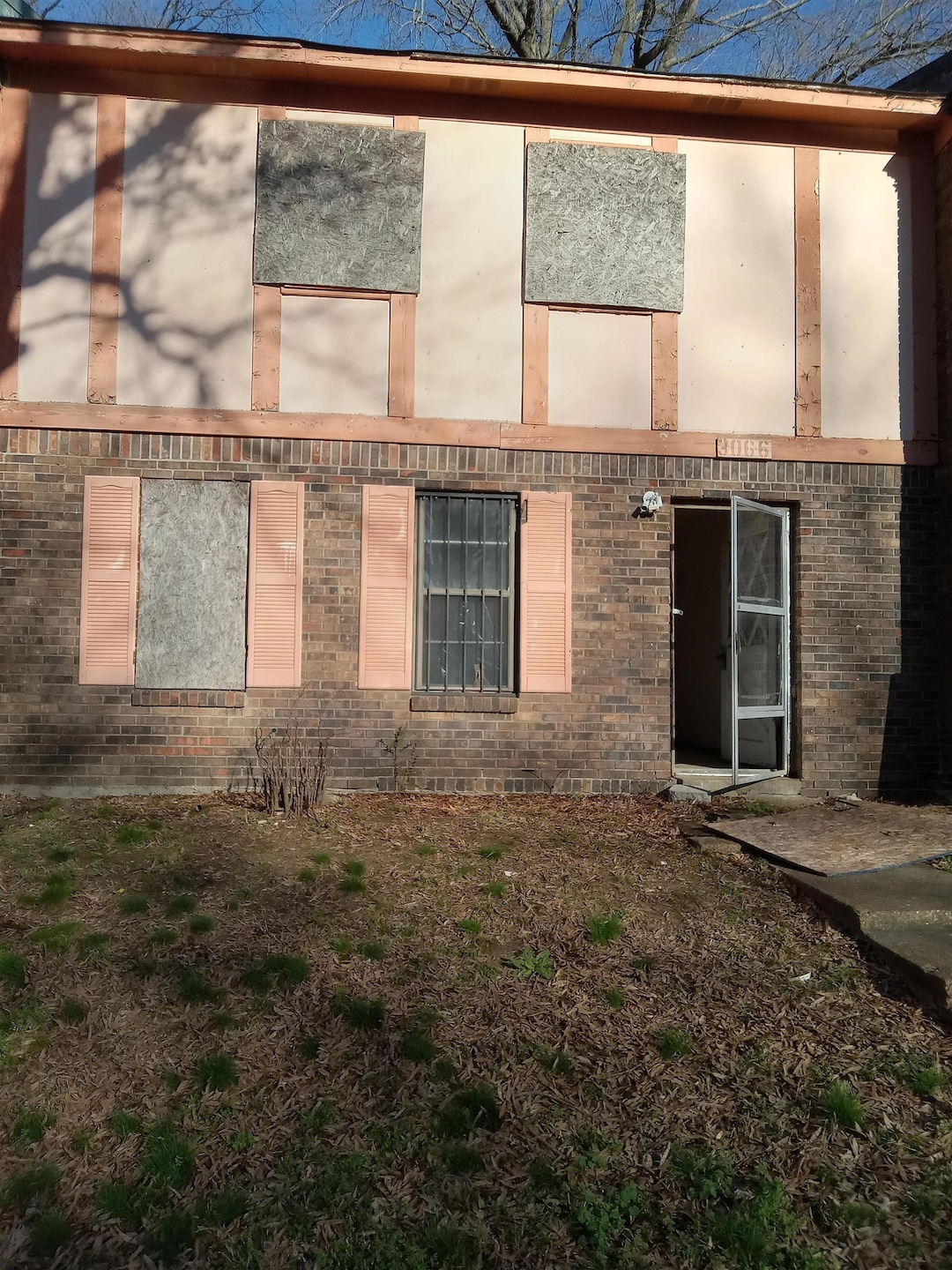 Back of property featuring brick siding