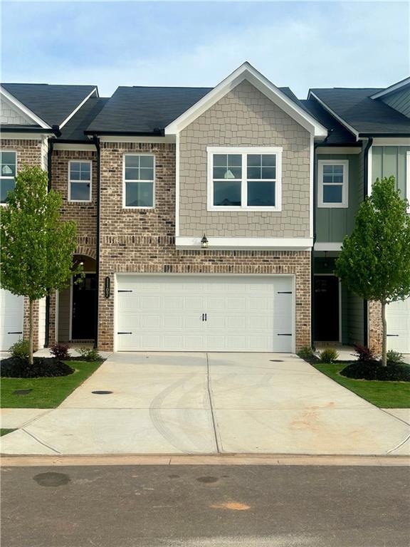 View of front of property featuring a garage