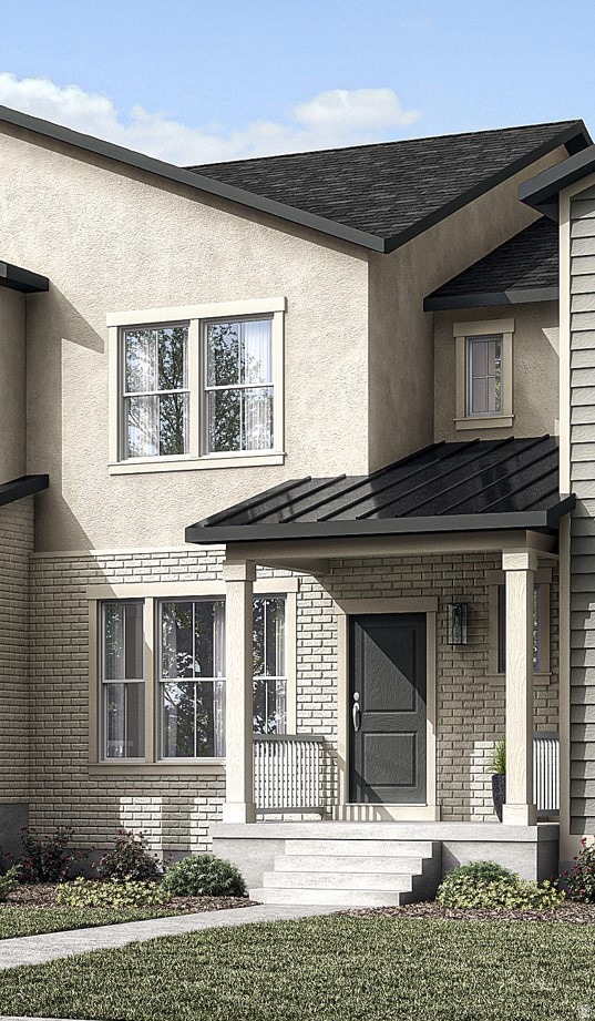 Property entrance featuring brick siding and stucco siding