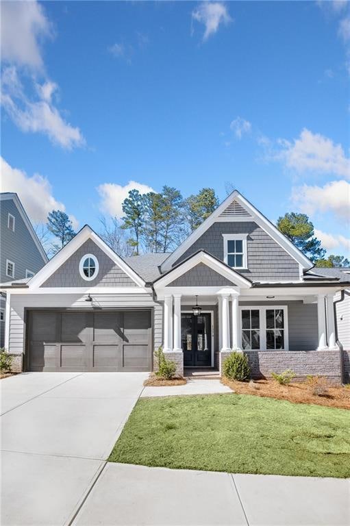 View of front of home with a garage, french doors,