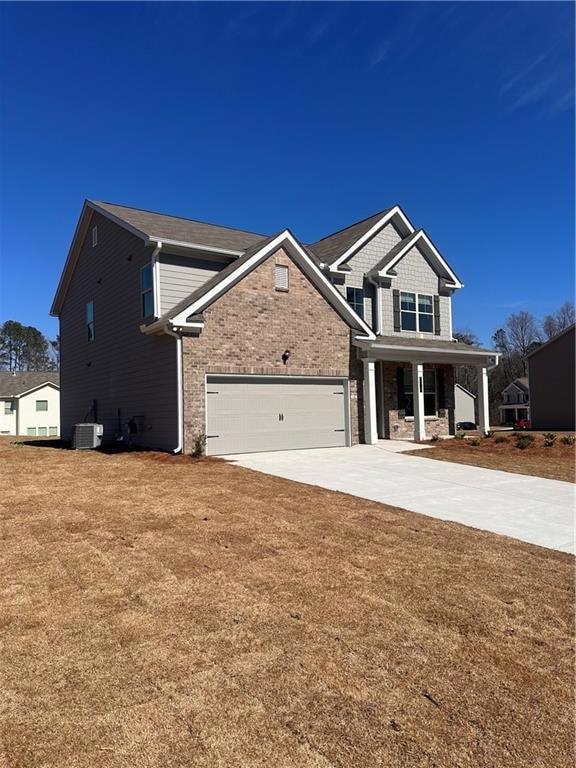 View of front of home featuring a front yard, conc