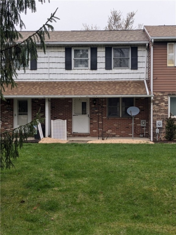 Front of Condo with yard and pine trees