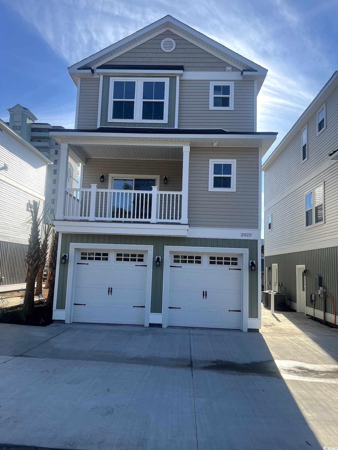 Front of property with a balcony and a garage