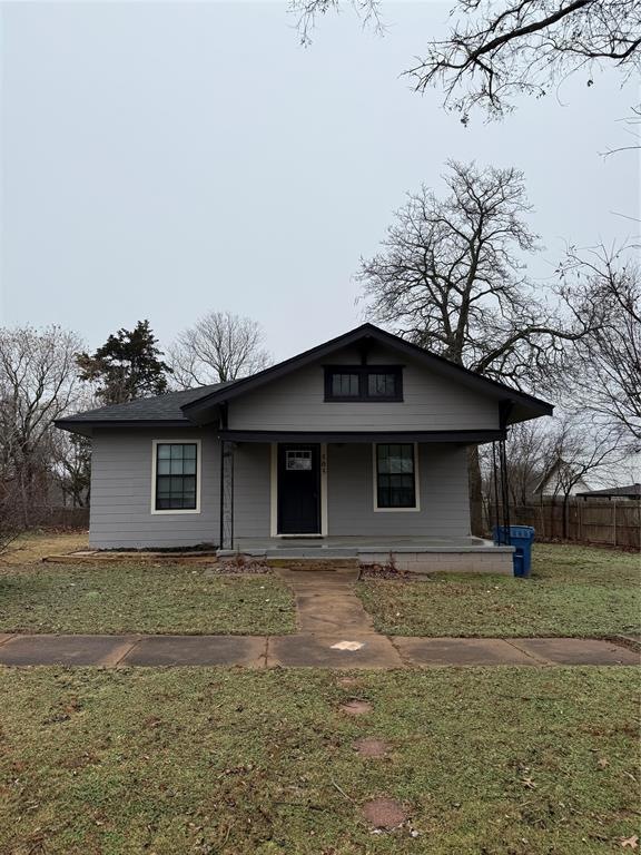View of front facade with a porch and a front yard
