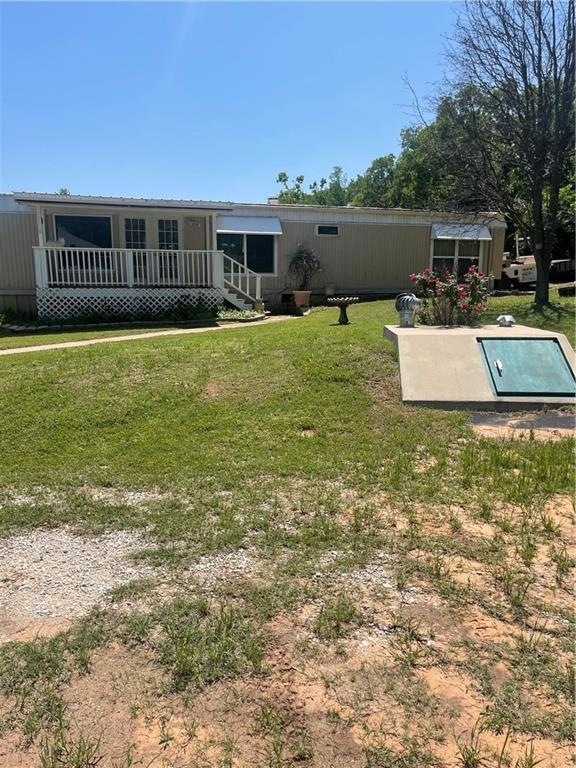 Front of single wide home and storm shelter