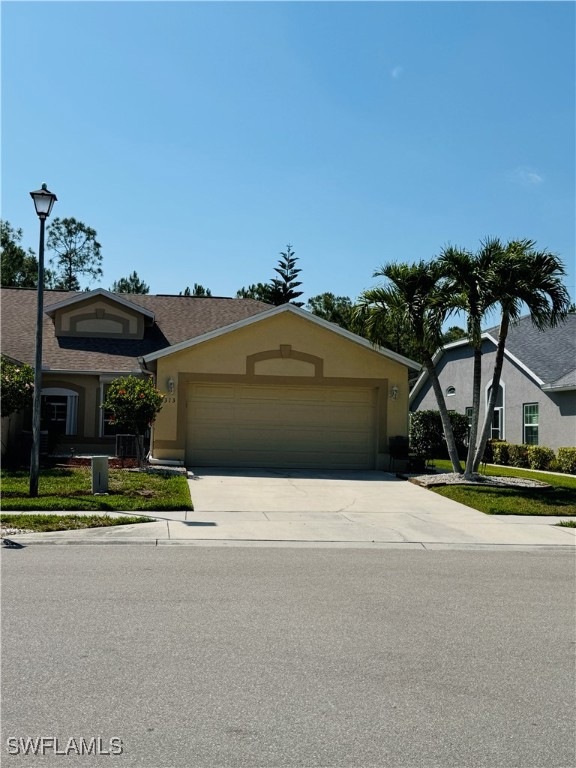 View of front facade with an attached garage, conc