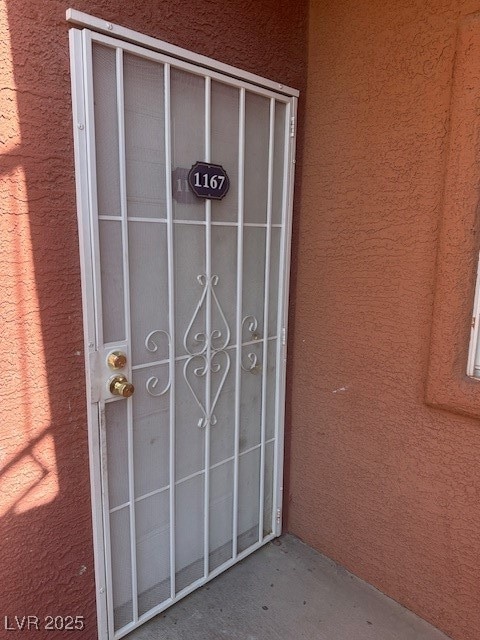 Doorway to property with stucco siding