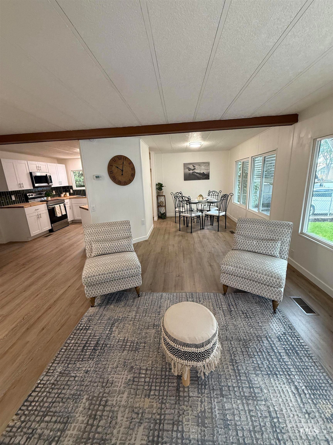 Living room featuring light wood-style floors and a textured ceiling