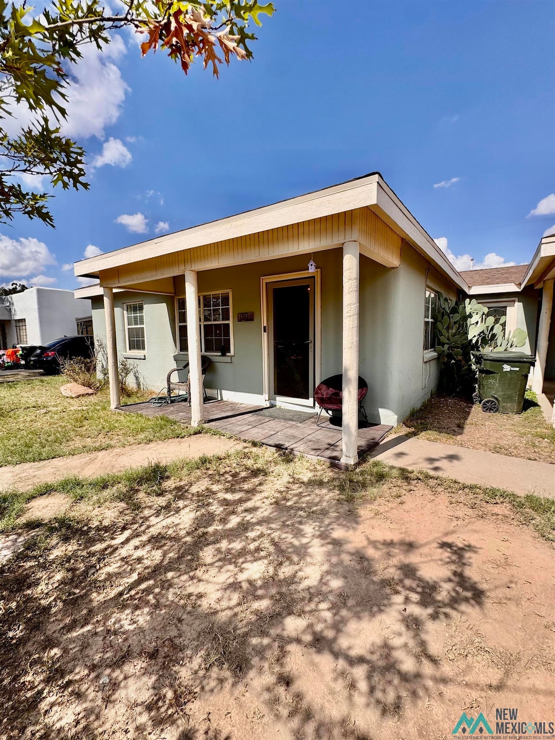 View of front facade featuring a porch and stucco siding