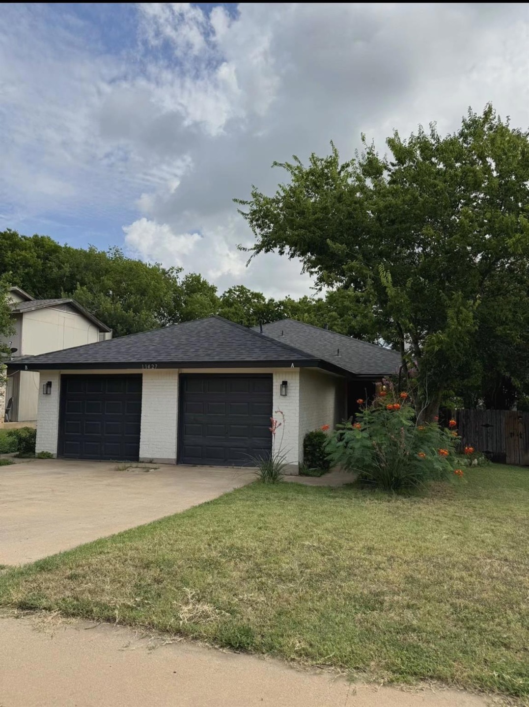 View of front of house featuring a garage, brick 