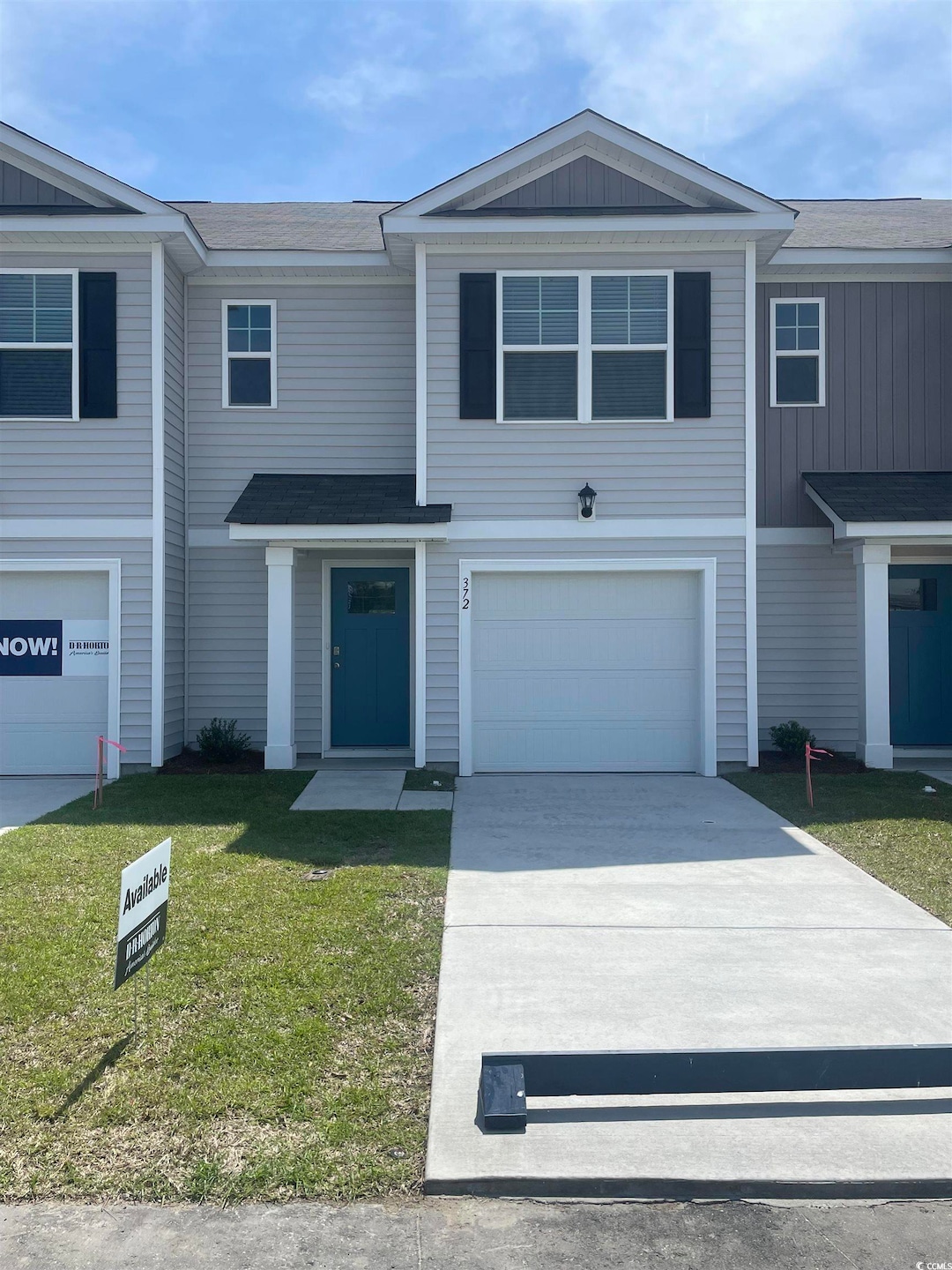 Townhome / multi-family property featuring drivewa