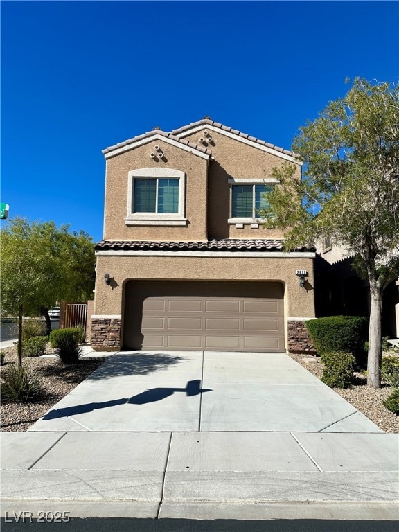 Mediterranean / spanish-style house featuring stone siding, stucco siding, driveway, and a garage