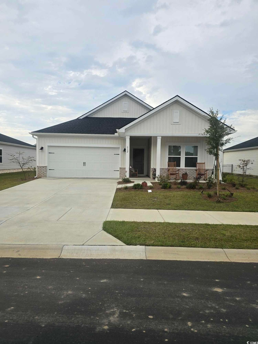 View of front of home featuring a porch and a garage