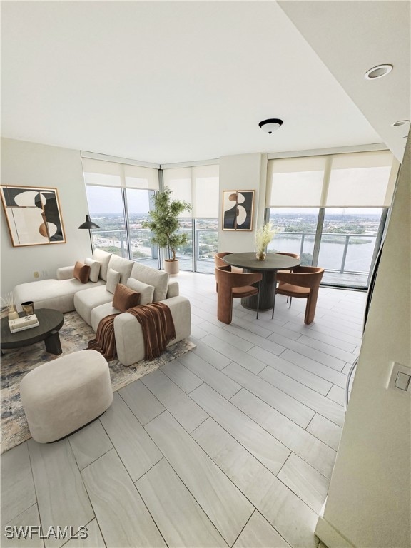 Living room featuring expansive windows and a wate