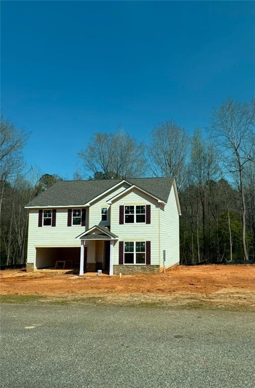 View of front of home with roof with shingles