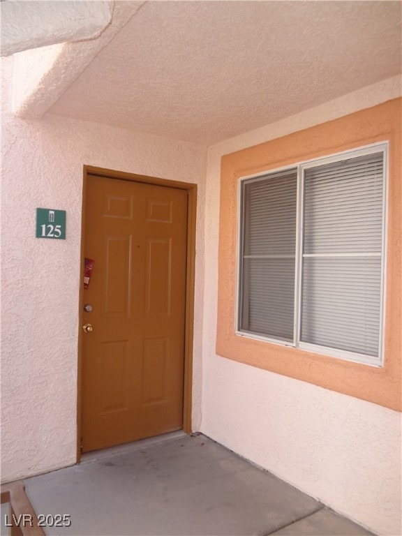 Property entrance with stucco siding