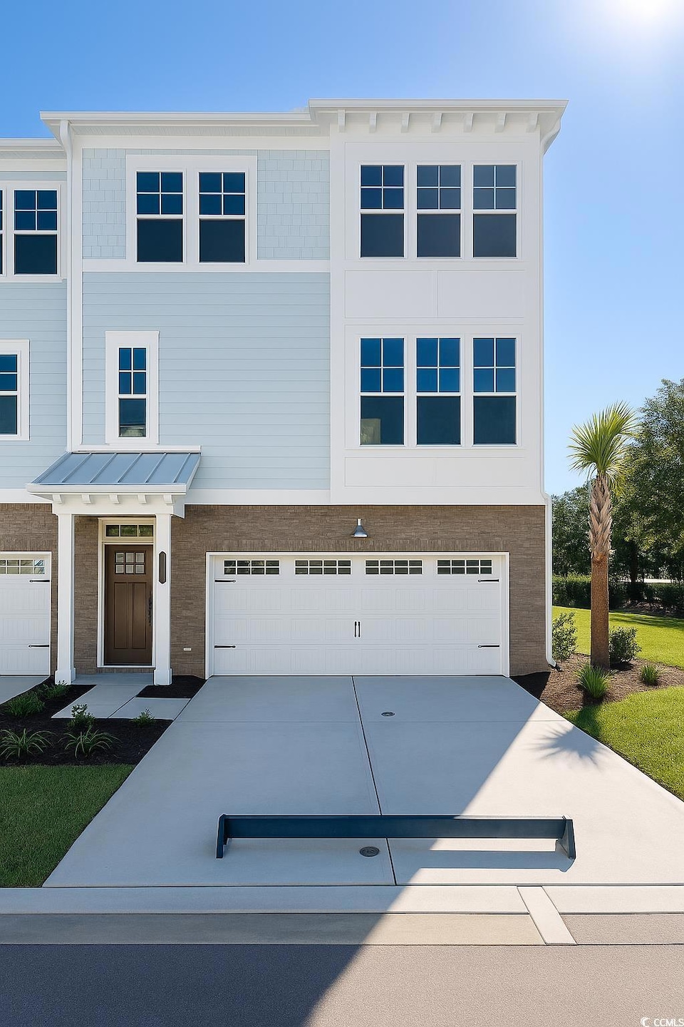 View of front of home featuring concrete driveway, brick siding, and an attached garage