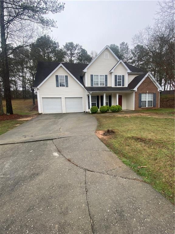 Front of property with a front yard and a garage