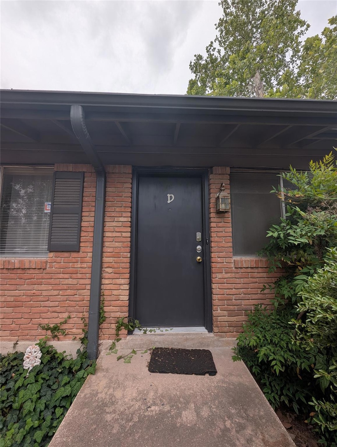 Entrance to property featuring brick siding