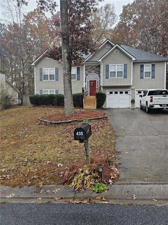 Split foyer home featuring a garage