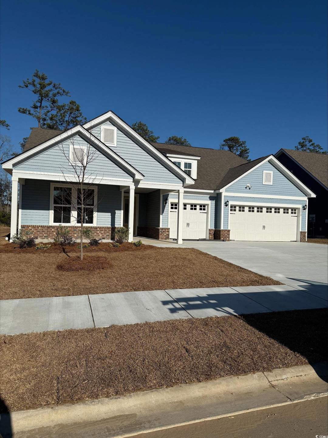 View of front of property with covered porch, bric