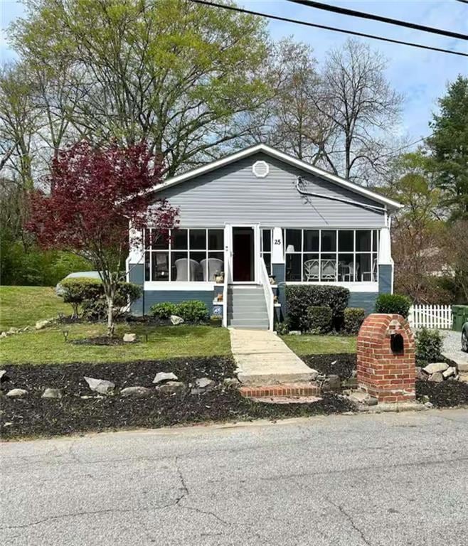 View of front of property featuring a sunroom