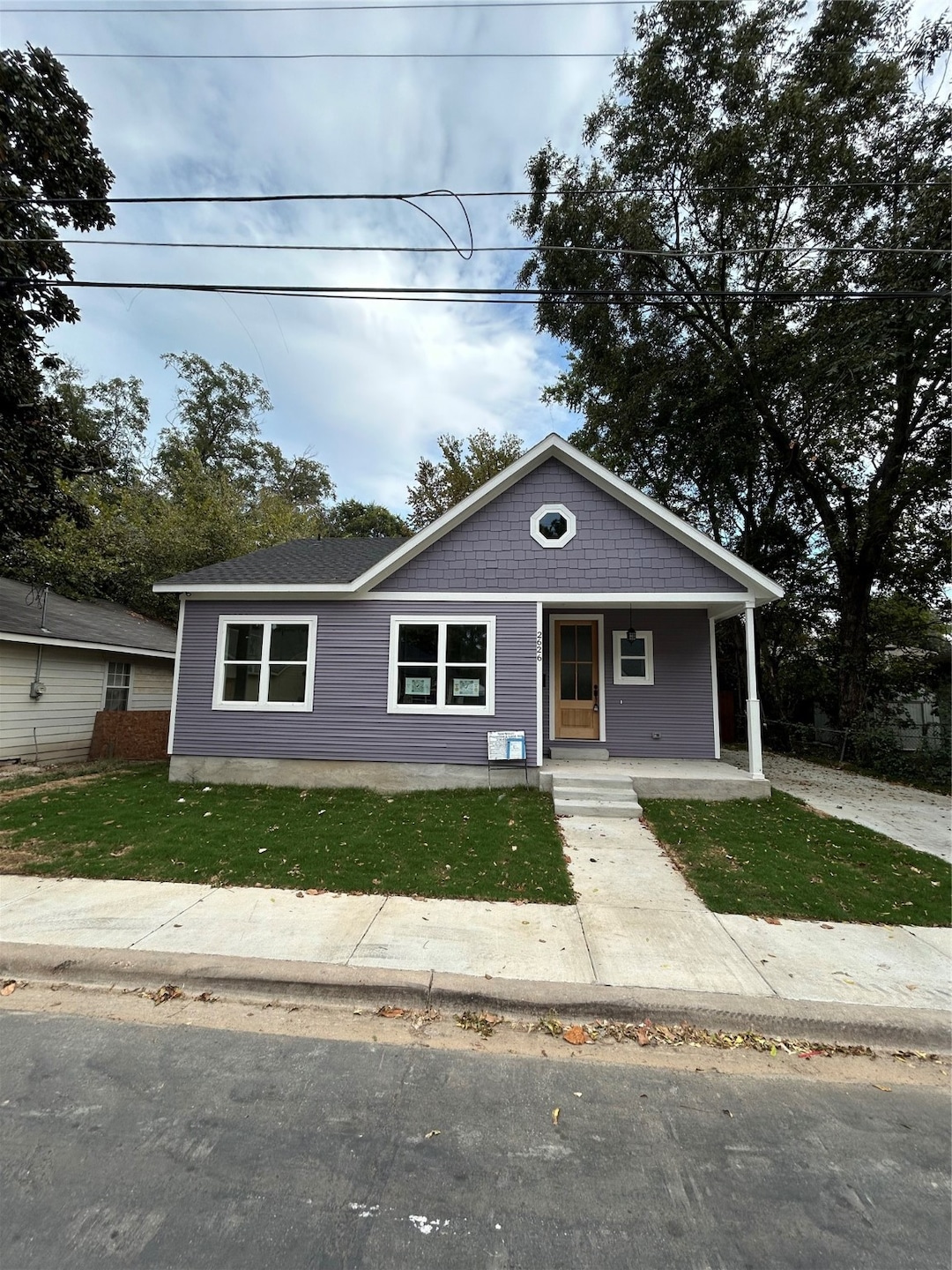 Bungalow-style home featuring covered porch and a front yard