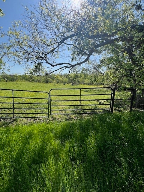 View of gate featuring a rural view and fence