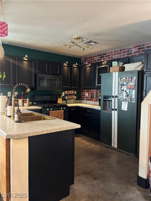 Kitchen featuring dark cabinetry, light countertop