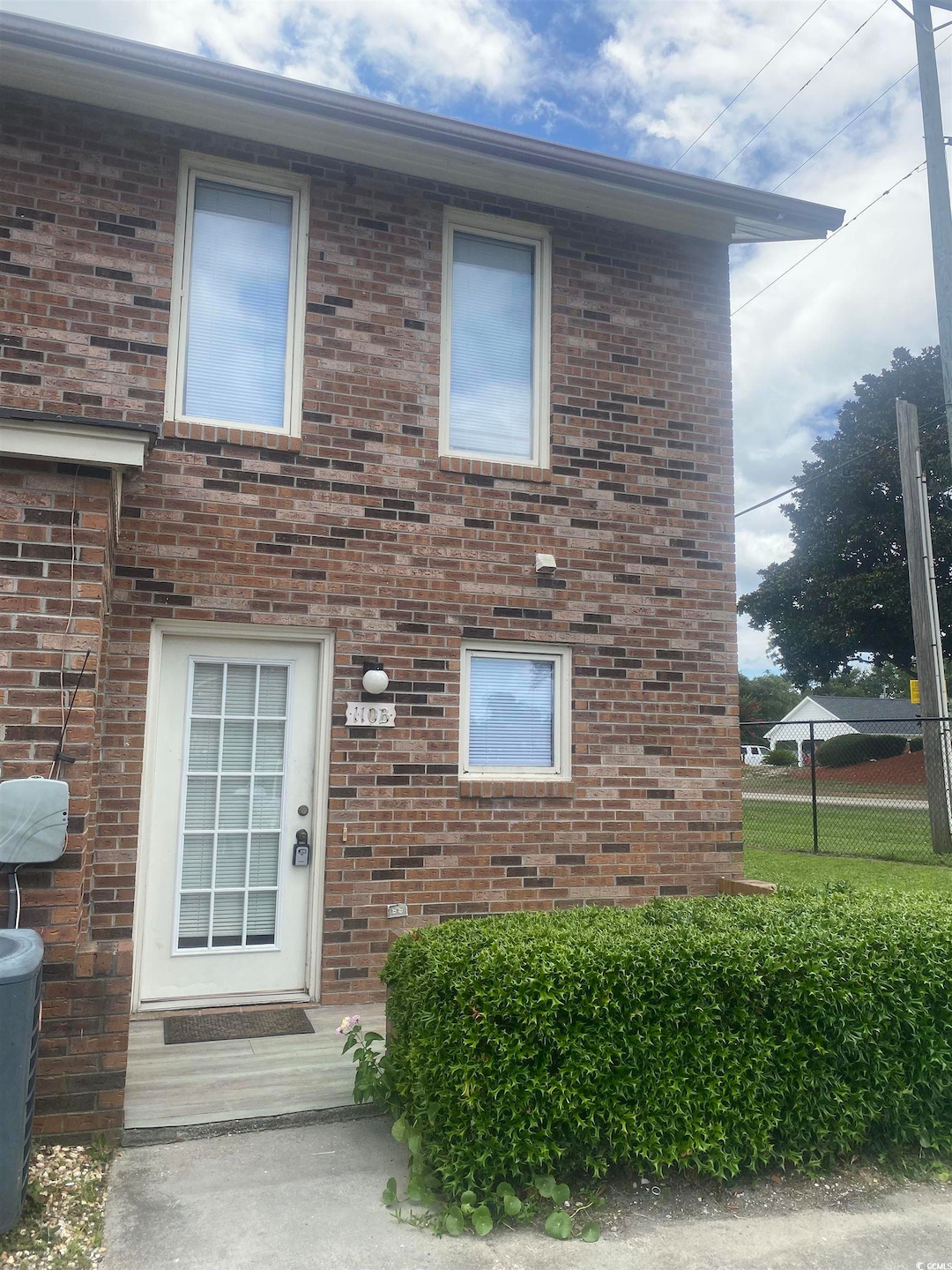 Doorway to property with brick siding