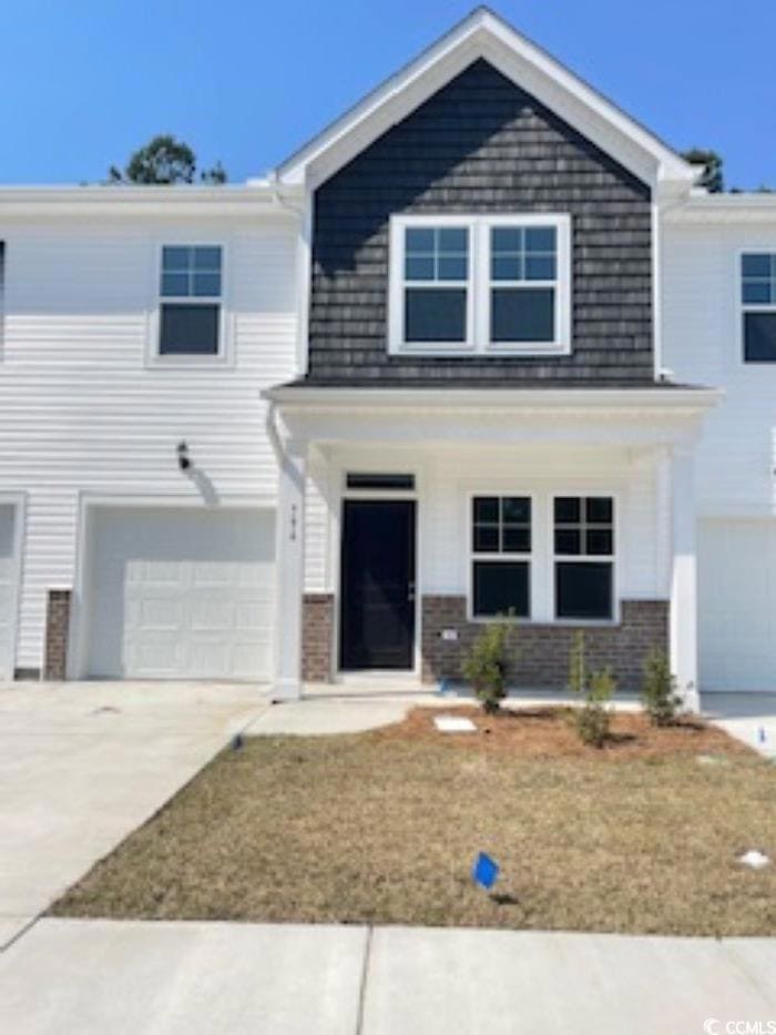 View of front of home featuring a garage, brick si