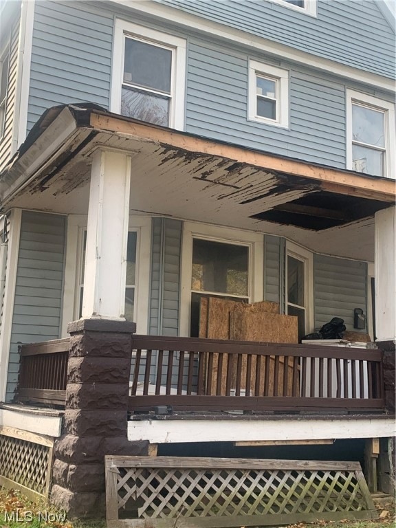 View of exterior entry with a porch